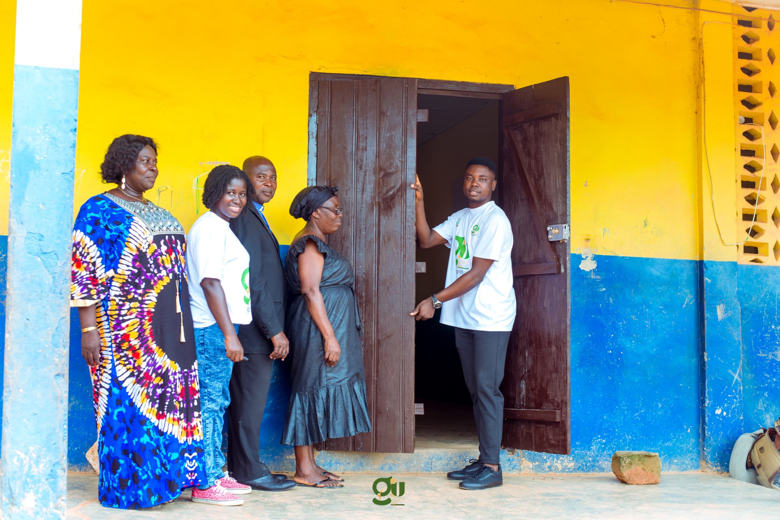 GIU classroom renovation — students celebrating with new desks