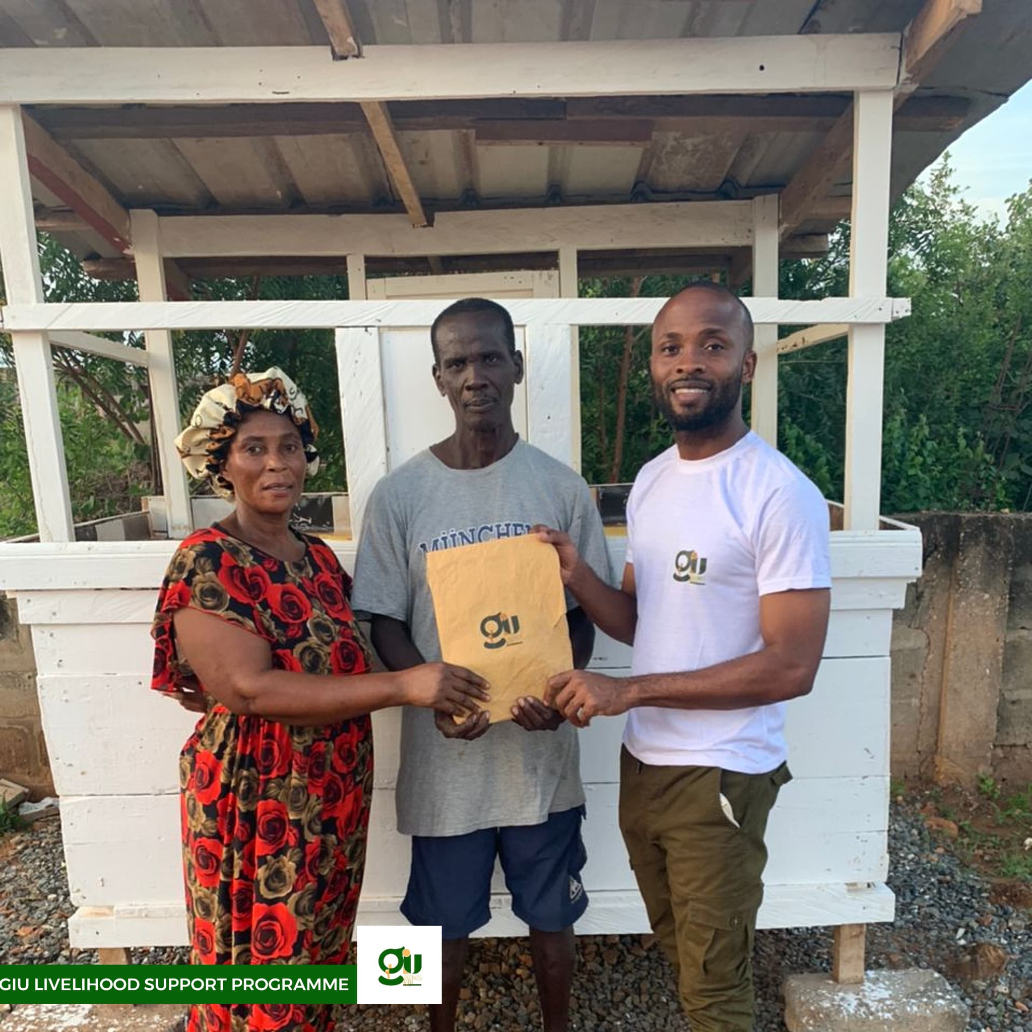 Paul presenting GIU livelihood support envelope to community member